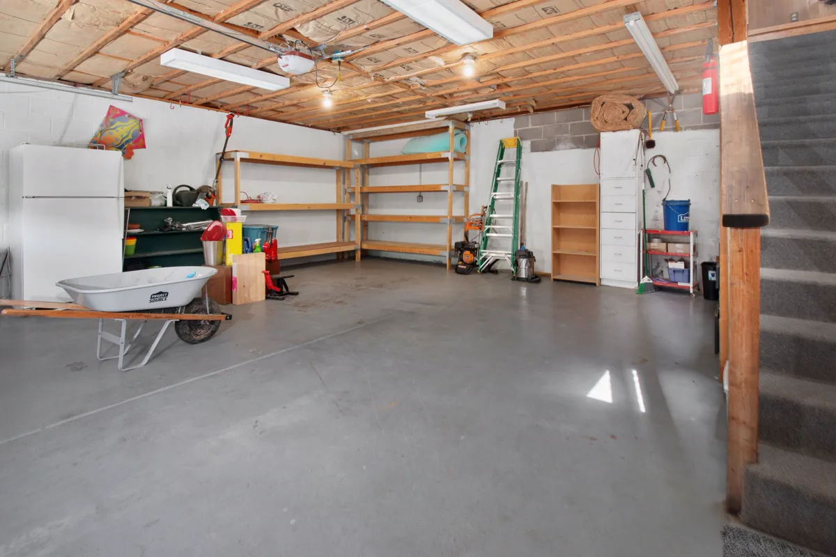A garage with a clear floor and everything on shelves