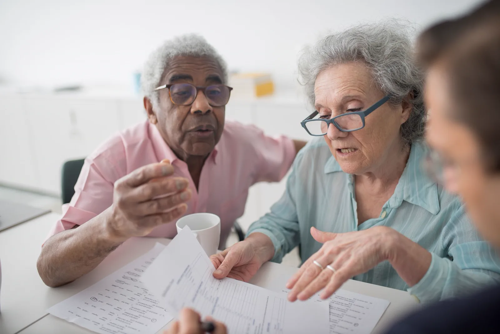 An older woman and her daughter going through the mail together