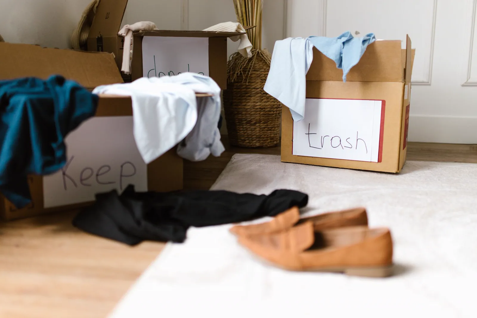 Boxes labeled keep, donate and trash during a sorting visit